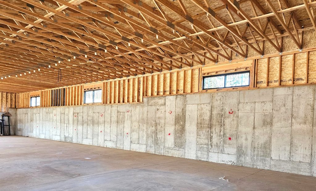 Interior view of a concrete wall serving as both a retaining wall and a structural building wall in a Layton, Utah office building.