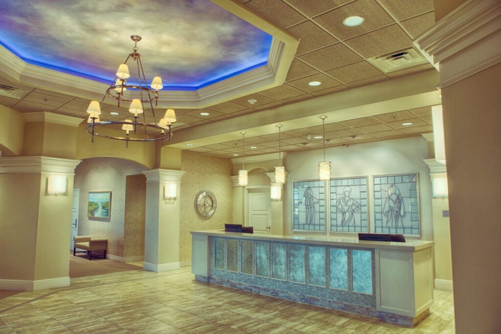 Main lobby with chandelier, sky-painted ceiling and reception desk at the Tanner Clinic Women's Center in Layton, Utah, built by PJF Corporation